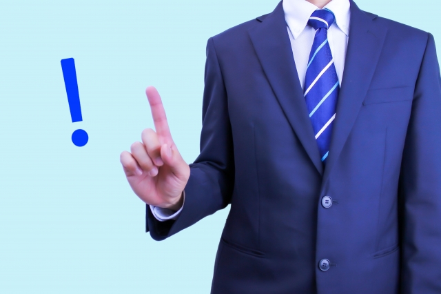 人差し指を立てるスーツ男性「!」